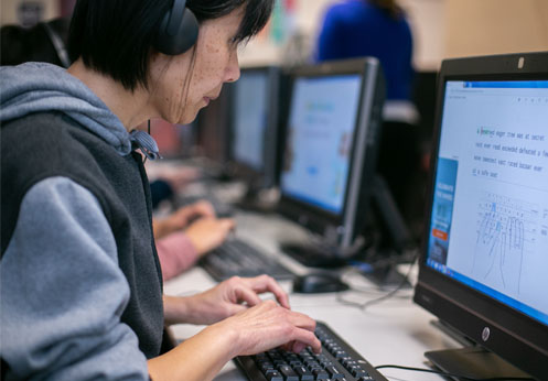 A NOCE disability support services student practicing touch typing on a computer.